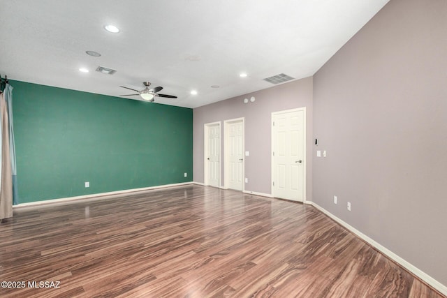 empty room with wood finished floors, ceiling fan, baseboards, and recessed lighting