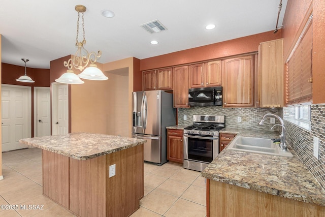 kitchen featuring stainless steel appliances, tasteful backsplash, light tile patterned floors, and a sink