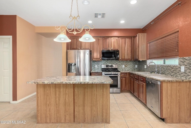 kitchen featuring tasteful backsplash, visible vents, appliances with stainless steel finishes, light tile patterned flooring, and a sink