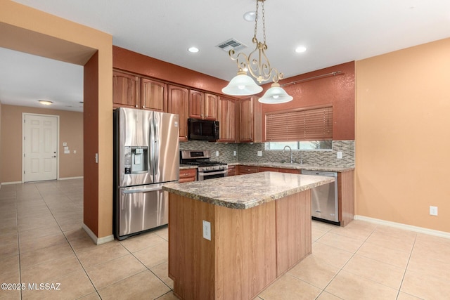 kitchen featuring stainless steel appliances, visible vents, backsplash, and light tile patterned flooring