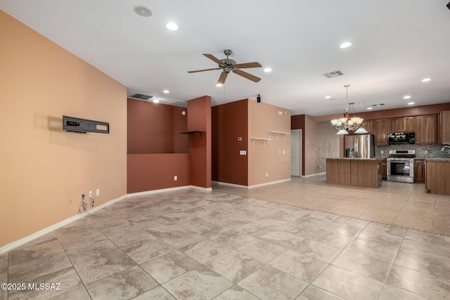 unfurnished living room featuring ceiling fan with notable chandelier, light tile patterned floors, baseboards, and visible vents