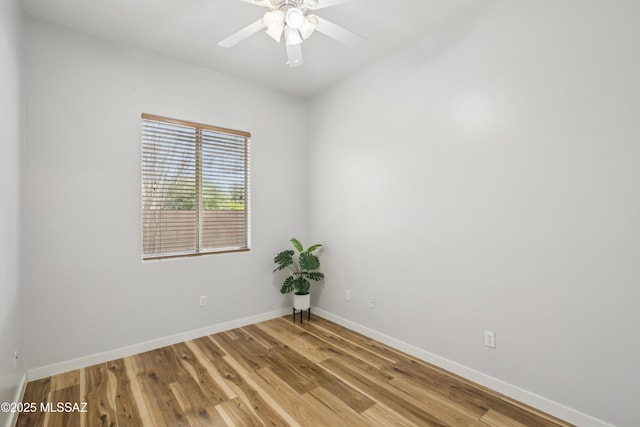 empty room featuring baseboards, a ceiling fan, and light wood finished floors