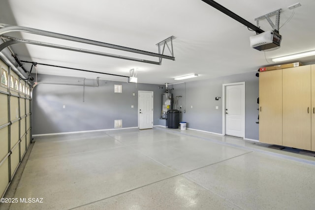 garage with baseboards, gas water heater, and a garage door opener