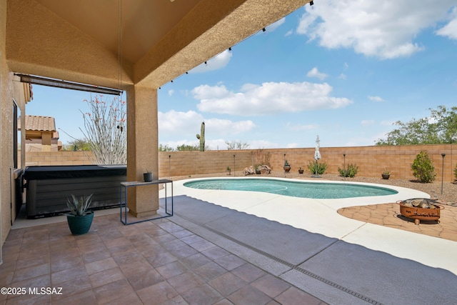 view of pool with a fenced in pool, a patio, a fenced backyard, and a hot tub