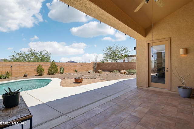 view of swimming pool with a fenced in pool, a patio, a fenced backyard, and ceiling fan