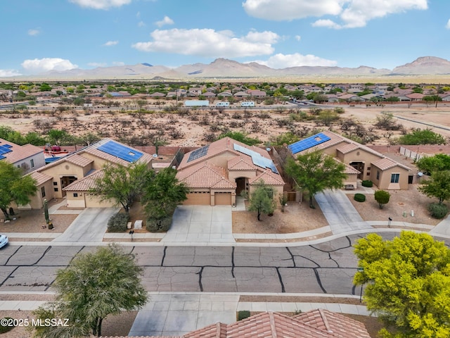 drone / aerial view featuring a mountain view, a residential view, and a desert view