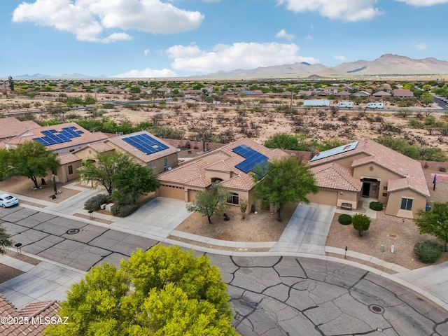 drone / aerial view featuring a mountain view and a desert view