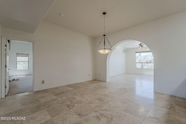 4247 W Flying Diamond Dr, Tucson, AZ 85742 - empty room with visible vents, arched walkways, and ceiling fan