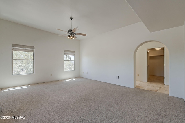 4247 W Flying Diamond Dr, Tucson, AZ 85742 - spare room with arched walkways, a ceiling fan, and light carpet