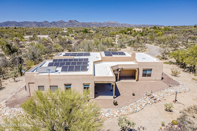 4247 W Flying Diamond Dr, Tucson, AZ 85742 - rear view of property with a mountain view, solar panels, stucco siding, and a patio area