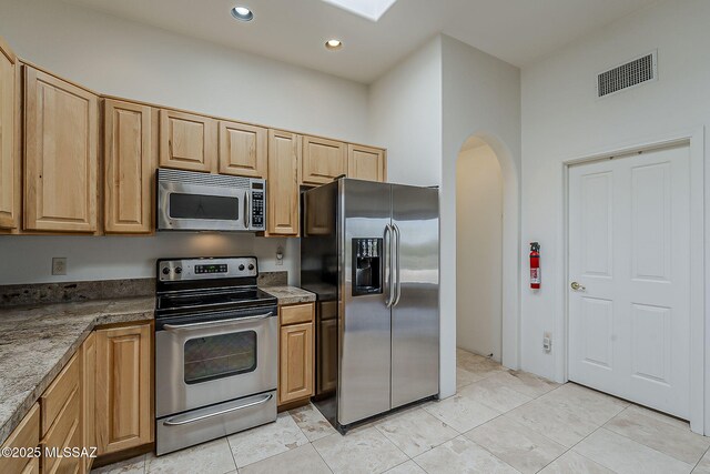 4247 W Flying Diamond Dr, Tucson, AZ 85742 - kitchen featuring recessed lighting, arched walkways, light brown cabinets, stainless steel appliances, and visible vents