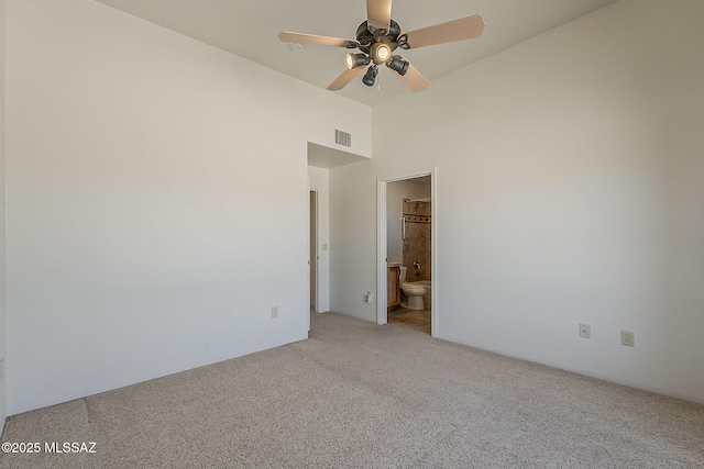 4247 W Flying Diamond Dr, Tucson, AZ 85742 - unfurnished room with visible vents, ceiling fan, vaulted ceiling, and light carpet