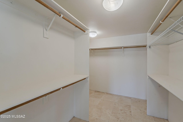 4247 W Flying Diamond Dr, Tucson, AZ 85742 - walk in closet featuring light tile patterned flooring