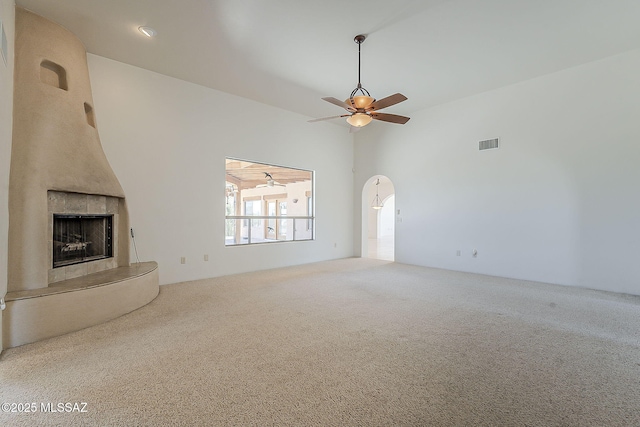 4247 W Flying Diamond Dr, Tucson, AZ 85742 - unfurnished living room with a fireplace with raised hearth, ceiling fan, carpet, and visible vents