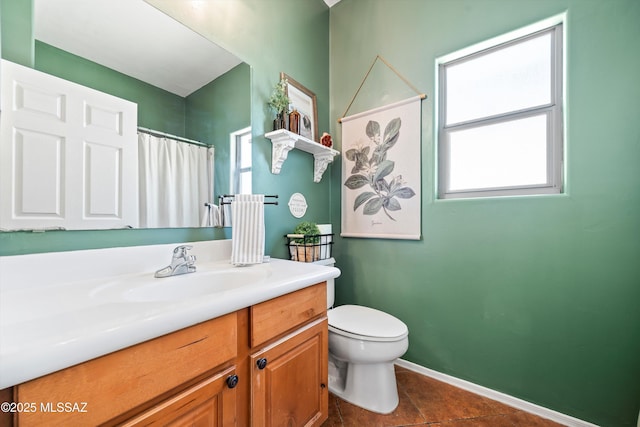 8167 S Placita Bilbao, Tucson, AZ 85747 - bathroom featuring toilet, vanity, tile patterned floors, baseboards, and a shower with shower curtain