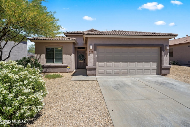 8167 S Placita Bilbao, Tucson, AZ 85747 - mediterranean / spanish-style home featuring concrete driveway, a garage, stucco siding, and a tiled roof