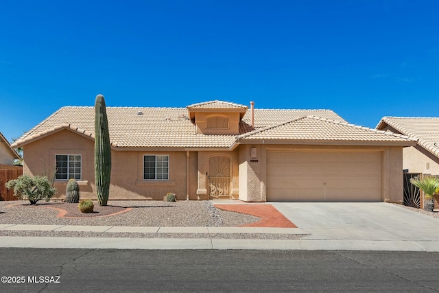 ranch-style house with a garage, a tiled roof, concrete driveway, stucco siding, and fence