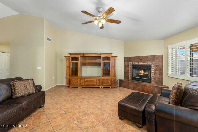 9622 E Paseo, San Ardo, Tucson, AZ 85747 - living room featuring lofted ceiling, a ceiling fan, a fireplace, and light tile patterned floors