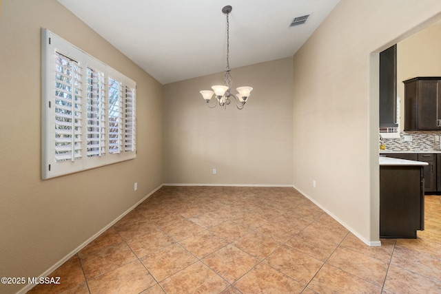 9622 E Paseo, San Ardo, Tucson, AZ 85747 - unfurnished dining area with light tile patterned floors, a chandelier, lofted ceiling, and baseboards