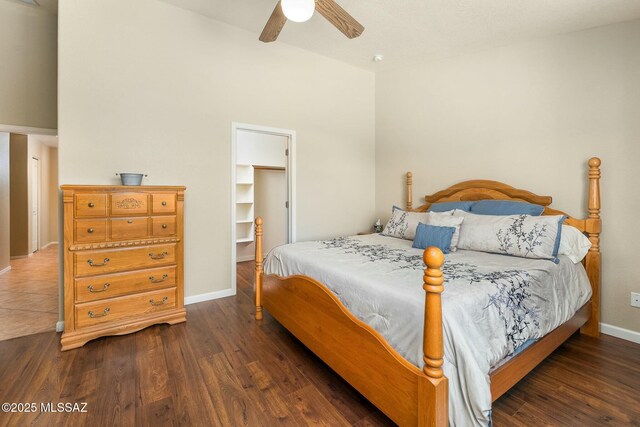 bedroom with baseboards, wood finished floors, and ceiling fan