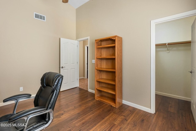 9622 E Paseo, San Ardo, Tucson, AZ 85747 - home office with baseboards, dark wood-style floors, and a towering ceiling