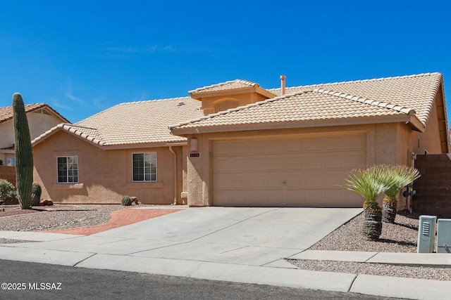 view of front facade featuring stucco siding, driveway, a tiled roof, and an attached garage