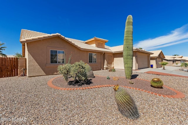 9622 E Paseo, San Ardo, Tucson, AZ 85747 - ranch-style home featuring stucco siding, a tile roof, an attached garage, fence, and driveway