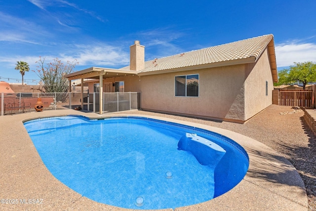 view of swimming pool featuring a patio, a fenced in pool, and a fenced backyard