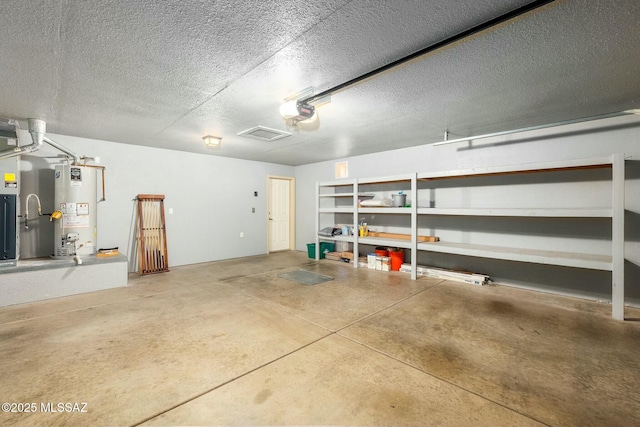 9622 E Paseo, San Ardo, Tucson, AZ 85747 - garage featuring water heater and a garage door opener