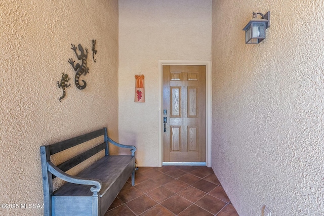 entrance to property featuring stucco siding
