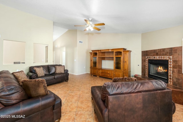 9622 E Paseo, San Ardo, Tucson, AZ 85747 - tiled living room featuring a ceiling fan, a tiled fireplace, and high vaulted ceiling