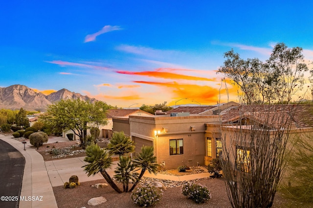 14045 N Desert Butte Dr, Oro Valley, AZ 85755 - pueblo revival-style home with stucco siding, a mountain view, and a garage