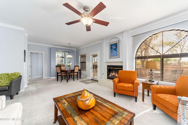 14045 N Desert Butte Dr, Oro Valley, AZ 85755 - living area with ceiling fan, a tile fireplace, baseboards, ornamental molding, and light carpet