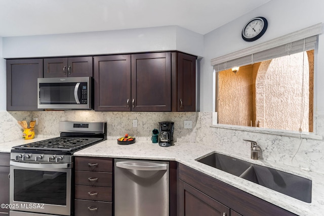 14045 N Desert Butte Dr, Oro Valley, AZ 85755 - kitchen featuring a sink, backsplash, stainless steel appliances, and dark brown cabinets
