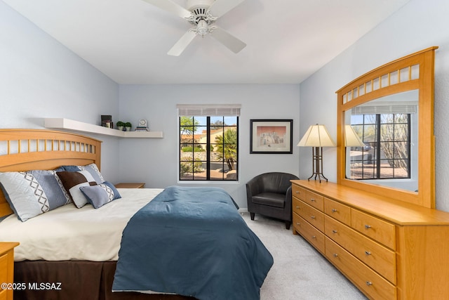 14045 N Desert Butte Dr, Oro Valley, AZ 85755 - bedroom with baseboards, ceiling fan, and light carpet