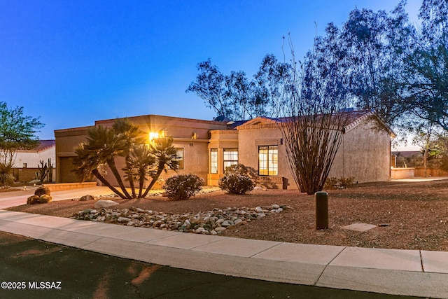 14045 N Desert Butte Dr, Oro Valley, AZ 85755 - view of front of house featuring a garage and stucco siding