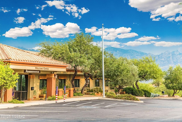 14045 N Desert Butte Dr, Oro Valley, AZ 85755 - view of building exterior featuring uncovered parking and a mountain view