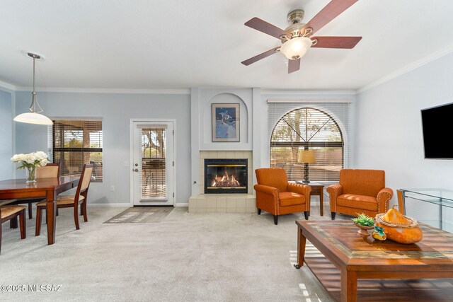 14045 N Desert Butte Dr, Oro Valley, AZ 85755 - living room with a tiled fireplace, crown molding, light carpet, and ceiling fan