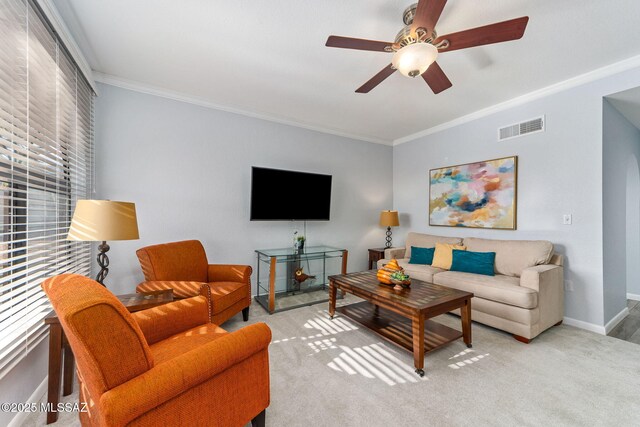 14045 N Desert Butte Dr, Oro Valley, AZ 85755 - carpeted living room featuring visible vents, ornamental molding, baseboards, and ceiling fan