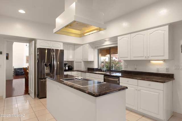 kitchen with white cabinets, range hood, a sink, and appliances with stainless steel finishes