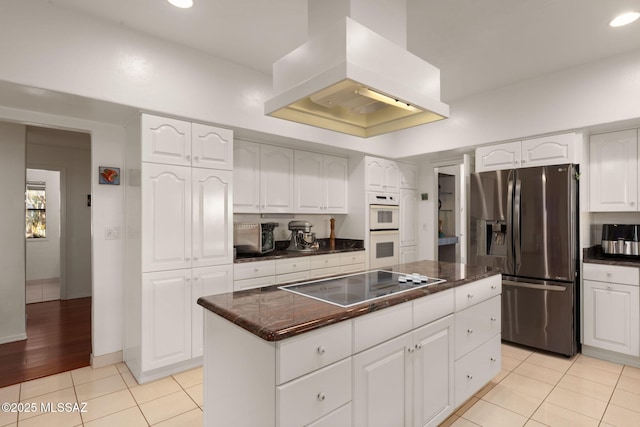 kitchen featuring black electric cooktop, light tile patterned flooring, extractor fan, stainless steel refrigerator with ice dispenser, and a kitchen island