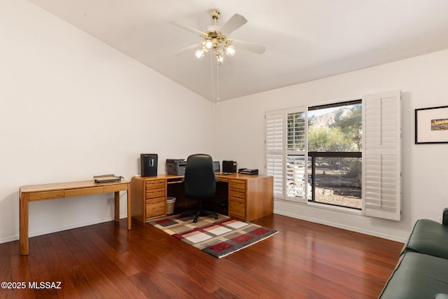 office area with a ceiling fan, baseboards, dark wood-type flooring, and vaulted ceiling