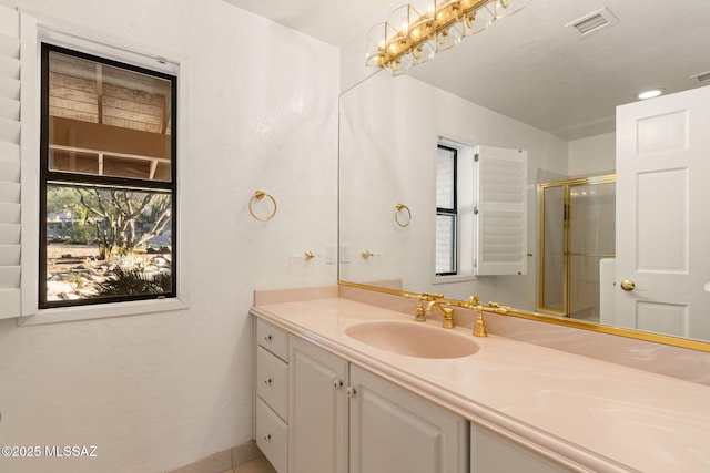 full bath featuring visible vents, vanity, and a stall shower