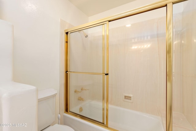 bathroom featuring shower / bath combination with glass door and toilet