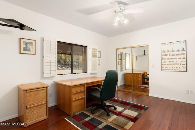 office space featuring baseboards, a ceiling fan, and dark wood-style floors
