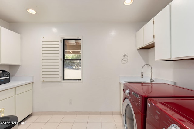 washroom with a sink, washer and clothes dryer, baseboards, recessed lighting, and cabinet space