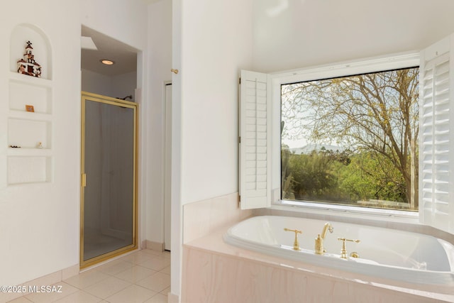 bathroom with a bath, baseboards, tile patterned floors, and a stall shower