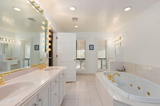 full bath with tile patterned flooring, a sink, visible vents, and a jetted tub
