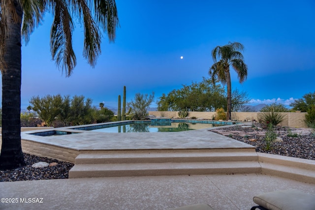 pool featuring fence and a patio area
