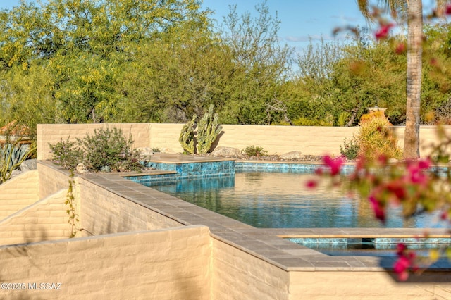 view of swimming pool featuring a fenced in pool and fence